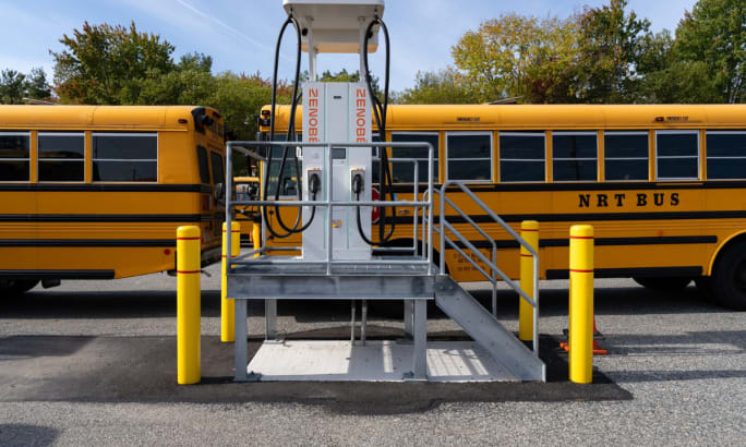 A Zenobē charger station in front of school buses.