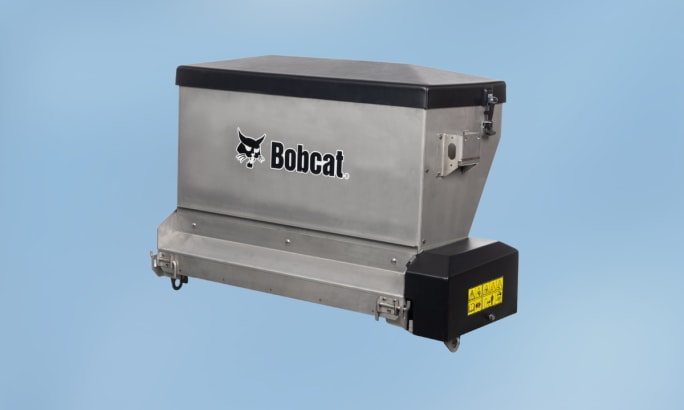 Bobcat drop spreader attachment for controlled distribution of salt, sand, or other materials.