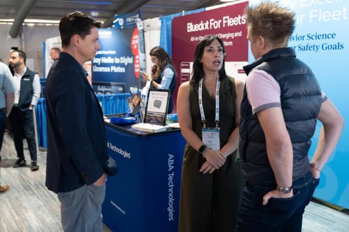 Attendees mix with exhibitors on show floor.