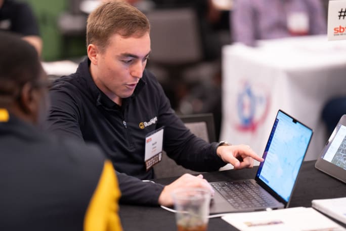 two people look at a computer