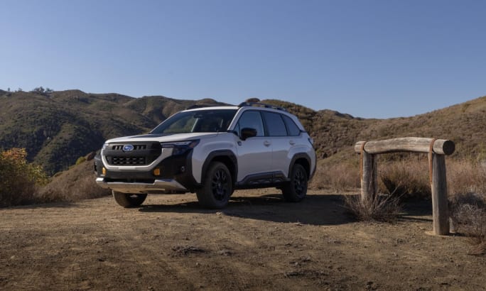 A white 2026 Subaru Forester Wilderness parked in front of hills.