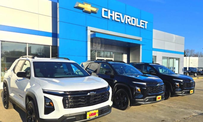 An image of the Richard Lucas Chevrolet building with a line of fleet cars parked out front.