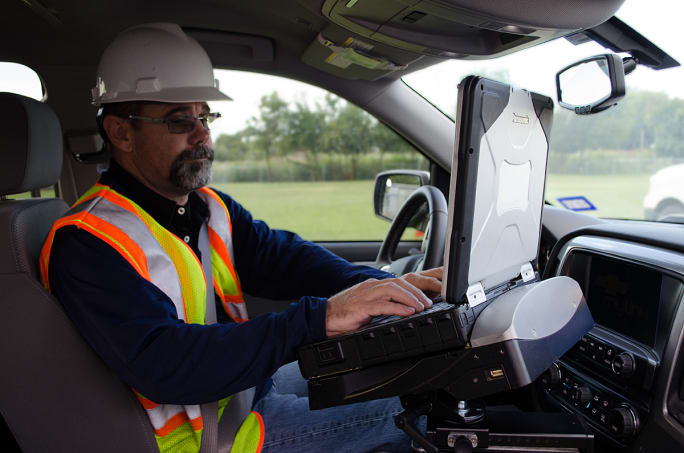 Driver in a truck cab on a rugged tablet