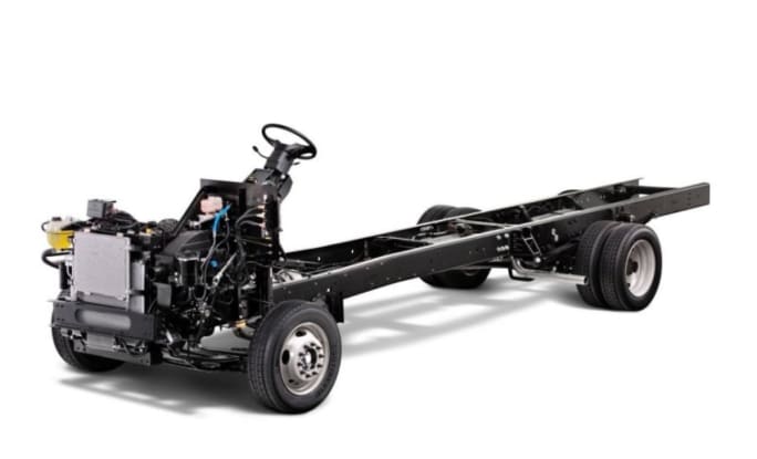 A Ford F-59 stripped chassis on a white background.