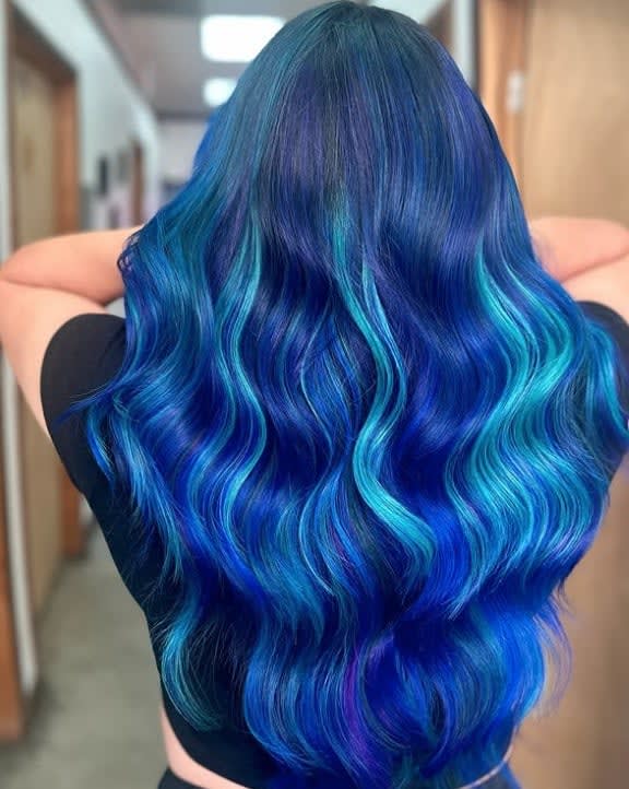 Very vibrant blue hair, very long and wavy.