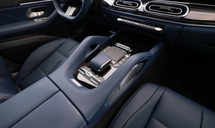 Close-up of Mercedes-Benz GLE center console with touch controls, leather trim, and modern infotainment interface.