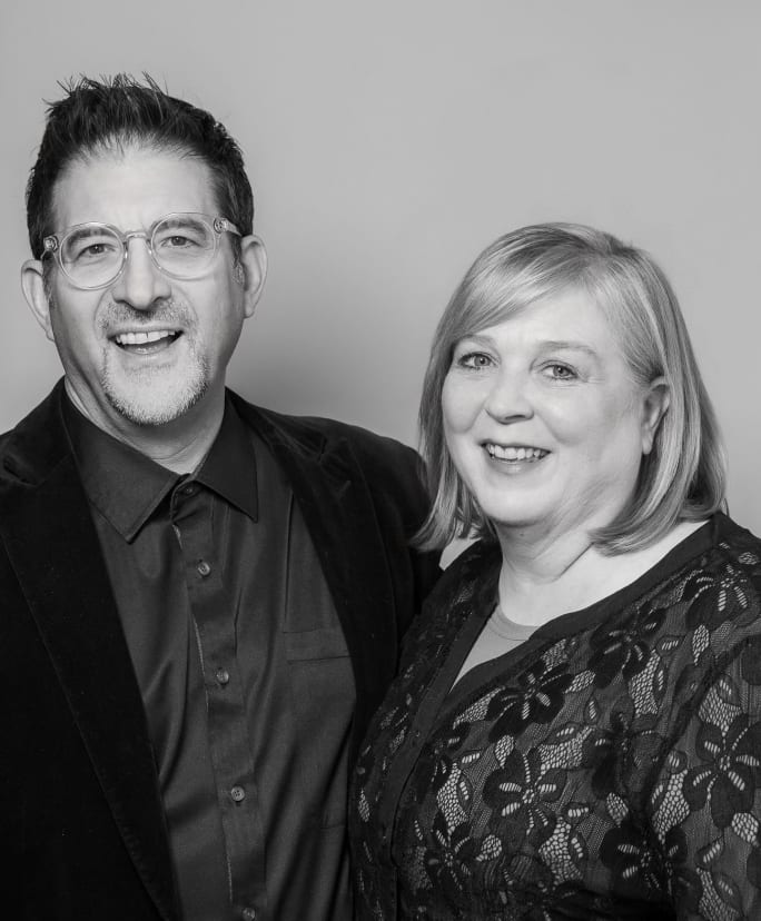 Smiling in a black and white portrait, Tony and Pam Gordon.