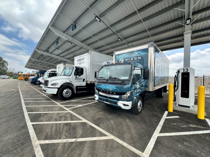 Trucks lined up to charge at depot. 