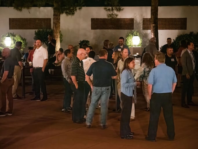 People networking in an outdoor courtyard reception