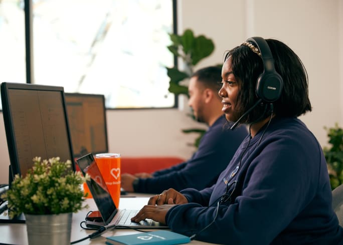 two people work at a computer
