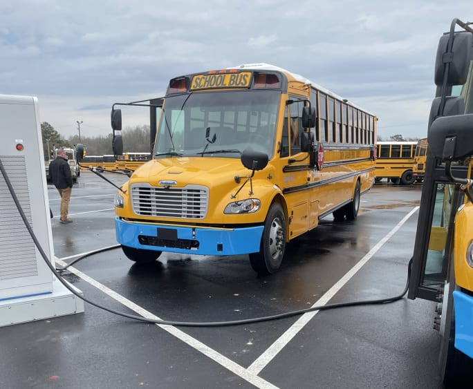 an EV school bus charges