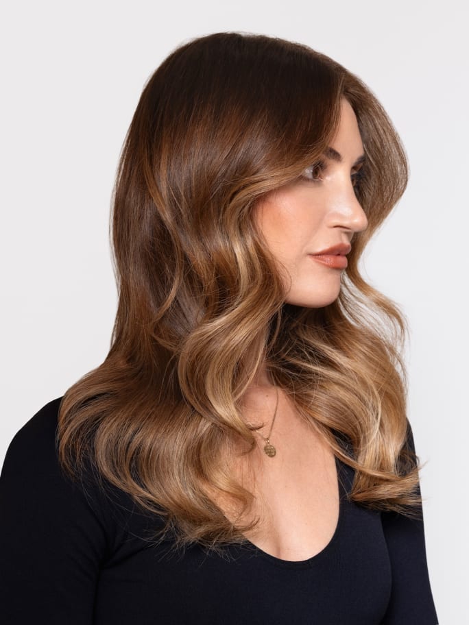 A brunette model wearing a scoop necked black tshirt