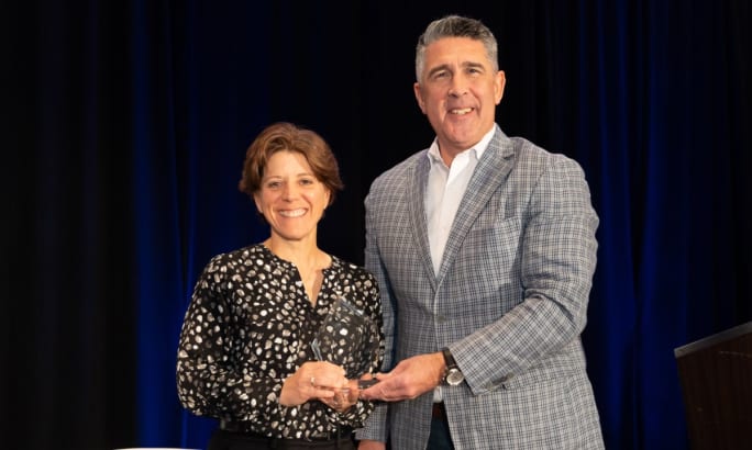 Sandra Doucette posing with the Fleet Safety Award presented by Mike Joyce.