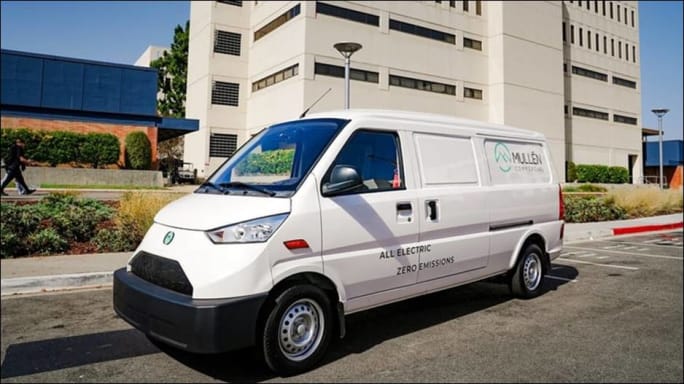 A Mullen Automotive van parked on the street.
