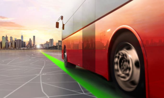 An image of a red bus driving on a cyber road toward a city.