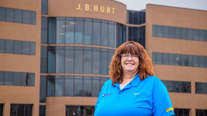 Woman truck driver in front of J.B. Hunt building