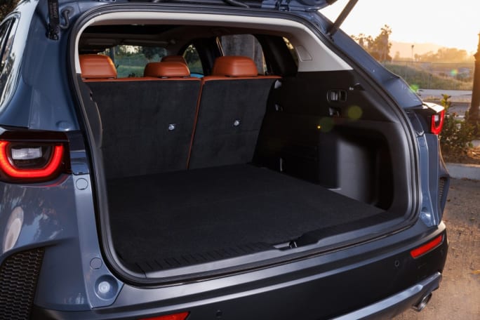 Trunk cargo space of a blue Mazda SUV.
