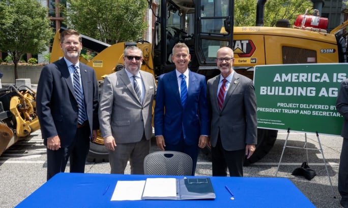 Secretary Duffy poses with Federal Highways Administrator Nominee Sean McMaster, Senator Ted Cruz and Executive Director of TxDOT Marc Williams in front of a tractor.