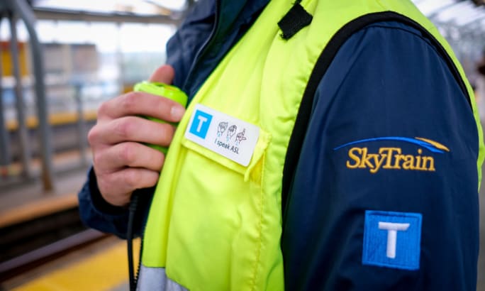 A TransLink SkyTrain worker wearing an ASL language pin.