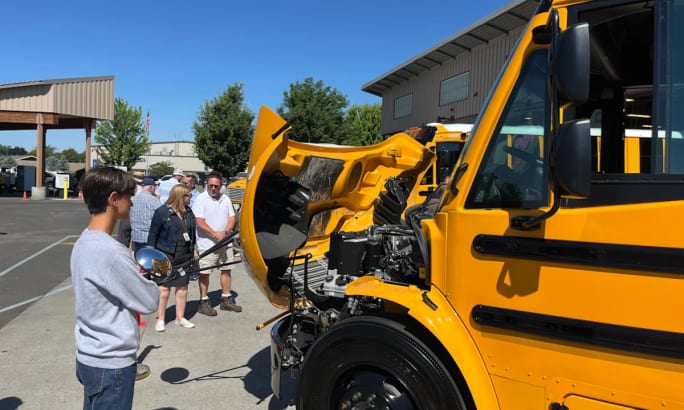 Event attendees taking a look at the new Walla Walla Public Schools electric buses.