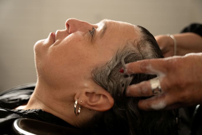 A woman having her hair shampooed