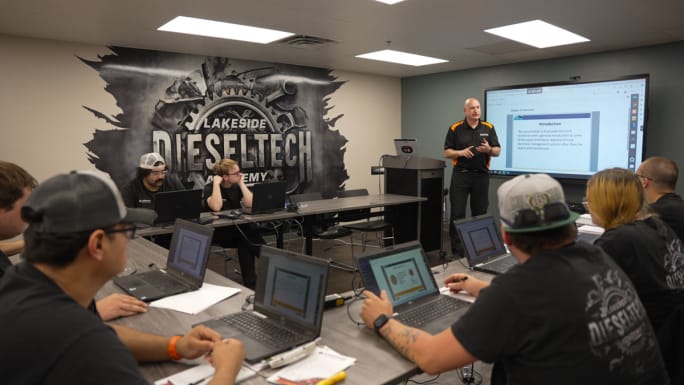 Diesel technician students with computers in small classroom
