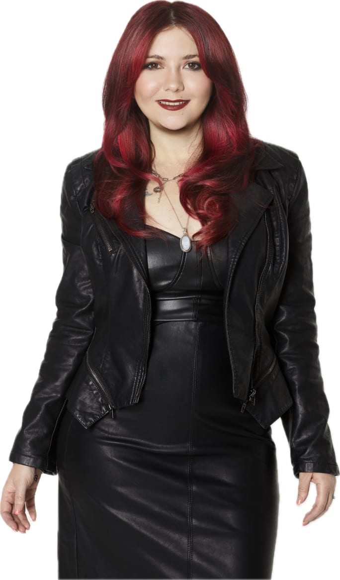 A smiling woman with red hair.