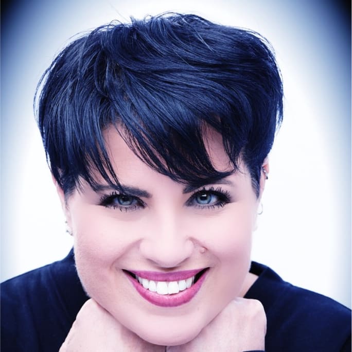 A smiling woman with short, dark hair.
