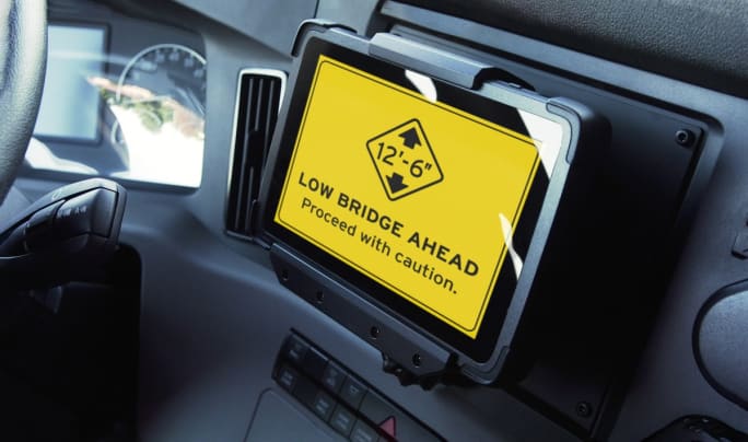 In-cab tablet showing low bridge ahead alert