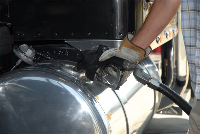 Gloved hand filling truck fuel tank with diesel