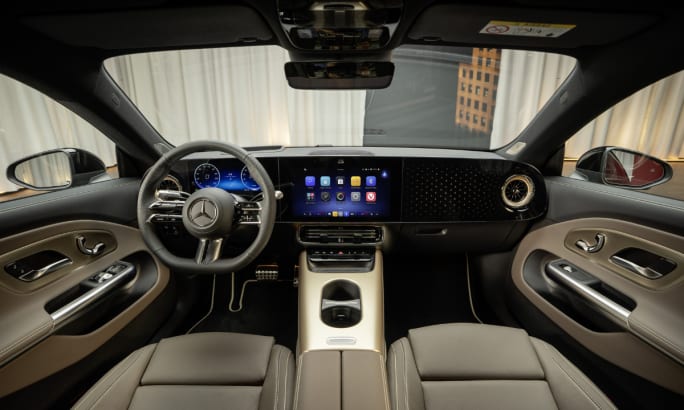 Tan and black interior of a 2026 Mercedes CLA sedan.