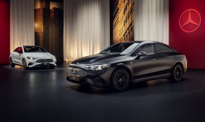 Two 2026 Mercedes CLA sedans in a showroom.