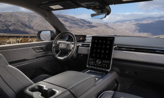 Interior dash and front seat of a 2026 GMC Sierra EV Elevation trim.