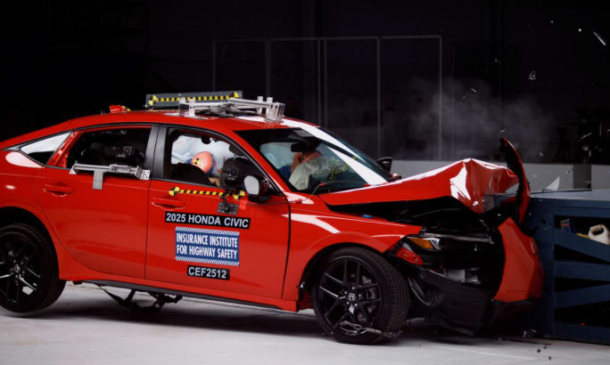 A red 2025 Honda Civic in a moderate overlap front crash test.