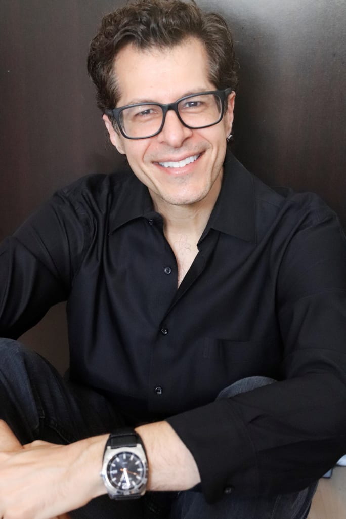 A smiling man with glasses
