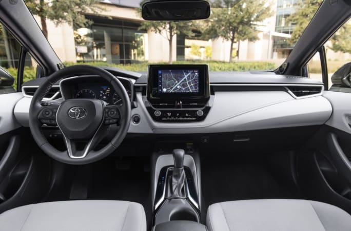 Gray and black front interior of a 2025 Toyota Corolla Hatchback.