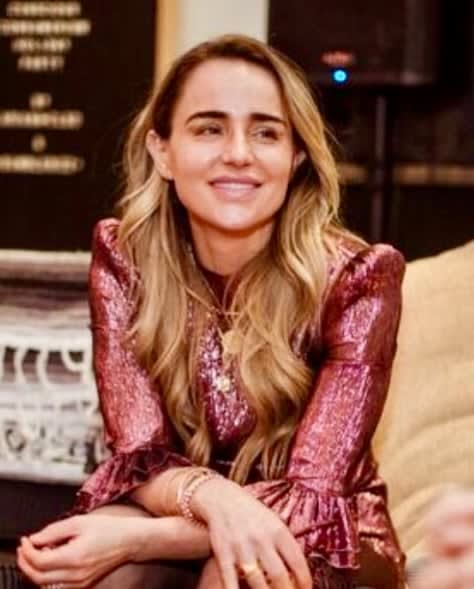 A young woman with long blonde hair in a sparkly pink dress.