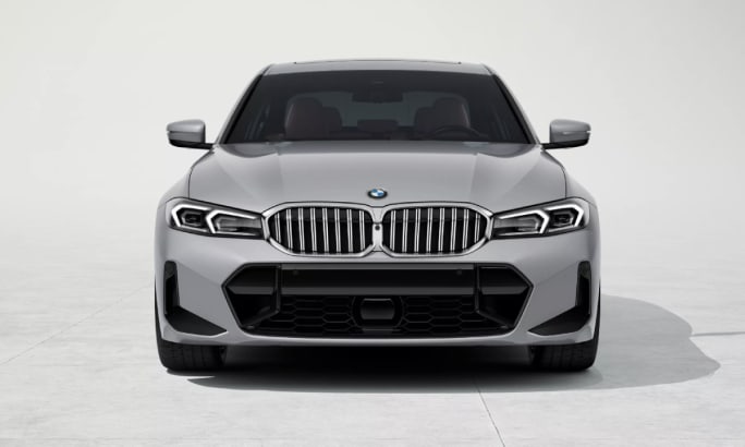 Front of a silver 2025 BMW 3 Series in a white showroom.