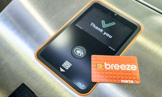 An orange fare card with the word 