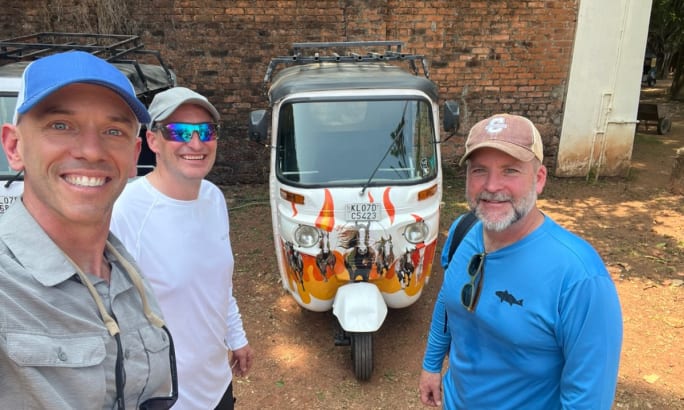 Mike Finnern poses with friends in front of their rickshaw set up.
