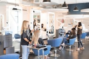 Two stylists work on clients at Ottalaus Salon.