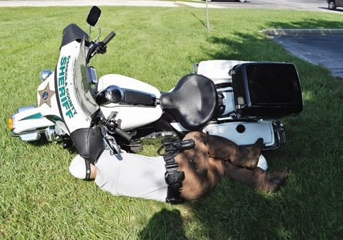 The motorcycle's engine helps provide cover. You'd be surprised at how much cover the vehicle can give you when lying on its side. Photo: Amaury Murgado