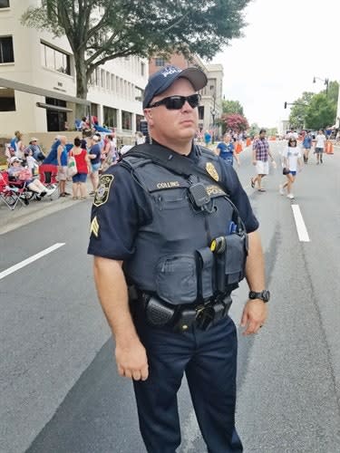 This officer standing watch over a public event is carrying a long gun in his sling bag. But most people would think he is toting much more innocuous supplies and gear. (Photo: Brian Marshall)