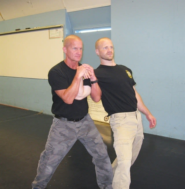 The Gooseneck and the Cow Paw are common standing control holds for active resisters. They control the arm and cause pain compliance. Photos: Adalyn Schlosser