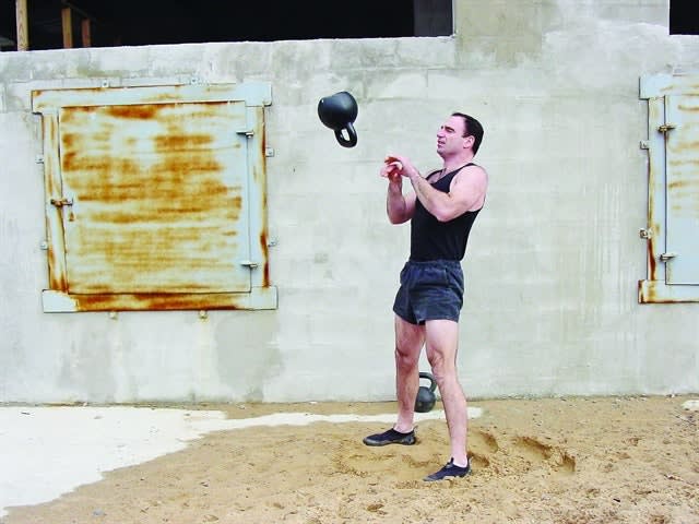 Jeff Martone of Tactical Athlete performs high-intensity kettlebell swing and catch exercises. Photo: Jeff Martone