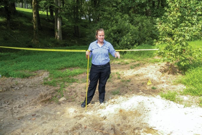 Forensic anthropologist Dr. Meredith Tise from the Pinellas County (FL) Sheriff's Office demonstrated how investigators use a metal probe to examine loose ground at a suspicious grave site. [|CREDIT|]Photo: David Griffith