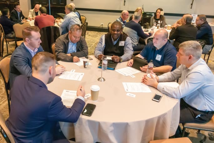 Law enforcement agency representatives discuss their technology challenges and possible solutions during PTX roundtable.[|CREDIT|]