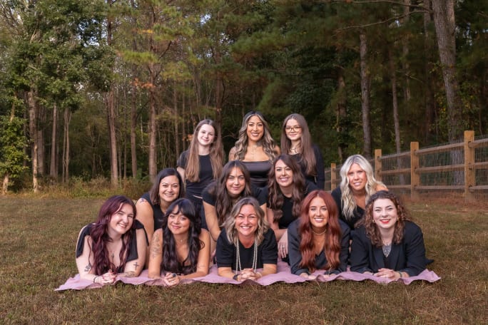 The team from Cynergy Color Bar in a pyramid formation.