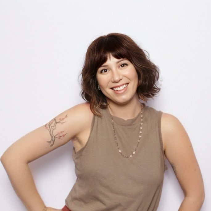 A woman posing and smiling with hands on hips.