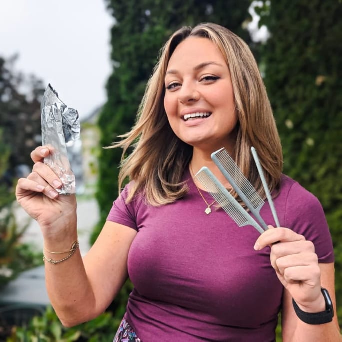 Sarah Babington holds salon foil in one hand and a comb in the other.